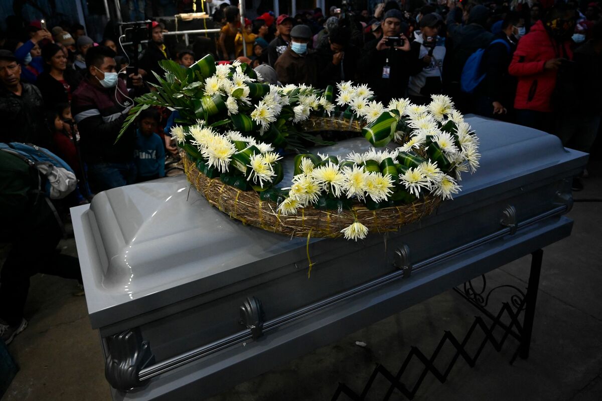 People attend the wake of Melvin Guachiac, a 13-year-old Guatemalan teenager who was killed inside a tractor-trailer in Texas after crossing from Mexico, at Tzucubal village in Nahuala, Guatemala, on July 15, 2022. Melvin Guachiac and his cousin Wilmer, both 13, were among the 51 migrants who died after they were abandoned in a suffocatingly hot tractor-trailer truck in the US state of Texas. (Photo by Johan ORDONEZ / AFP)