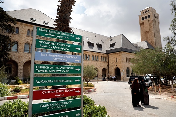 People walk outside of the Augusta Victoria hospital in East Jerusalem on September 9, 2018. - The United States plans to cut $25 million in aid to six hospitals primarily serving Palestinians in Jerusalem, a State Department official confirmed on September 8. The official said the decision followed a President Donald Trump-directed review of assistance to the Palestinian Authority and in the West Bank and Gaza "to ensure these funds were being spent in accordance with US national interests and were providing value to the US taxpayer." (Photo by - / AFP) (Photo credit should read -/AFP via Getty Images)