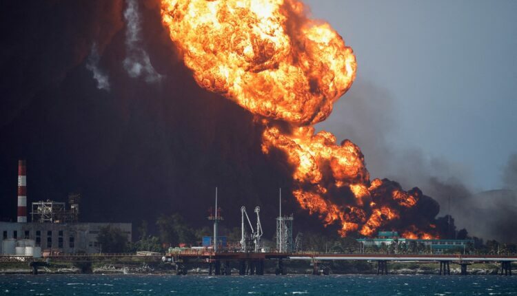 Fire is seen over fuel storage tanks that exploded near Cuba's supertanker port in Matanzas, Cuba, August 8, 2022. REUTERS/Alexandre Meneghini TPX IMAGES OF THE DAY