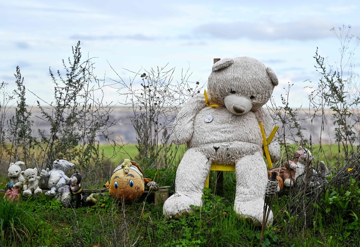 A photo shows a teddy bear with a yellow X, a symbol against nuclear waste shipments and nuclear power, next to other figurines, near the open-cast mine Garzweiler in Luetzerath, western Germany on October 16, 2022. German multinational energy company RWE plans to entirely demolish houses in the village of Luetzerath for coal mining. RWE also brought forward its exit from coal power to 2030 on October 4, 2022 amid fears the country's plans to abandon fossil fuels are wobbling following the energy crisis caused by Russia's war in Ukraine. Russia's curtailing of gas exports to Germany in the wake of the Ukraine war has forced Berlin to make the radical decision to restart mothballed coal power stations, at least temporarily. (Photo by INA FASSBENDER / AFP)