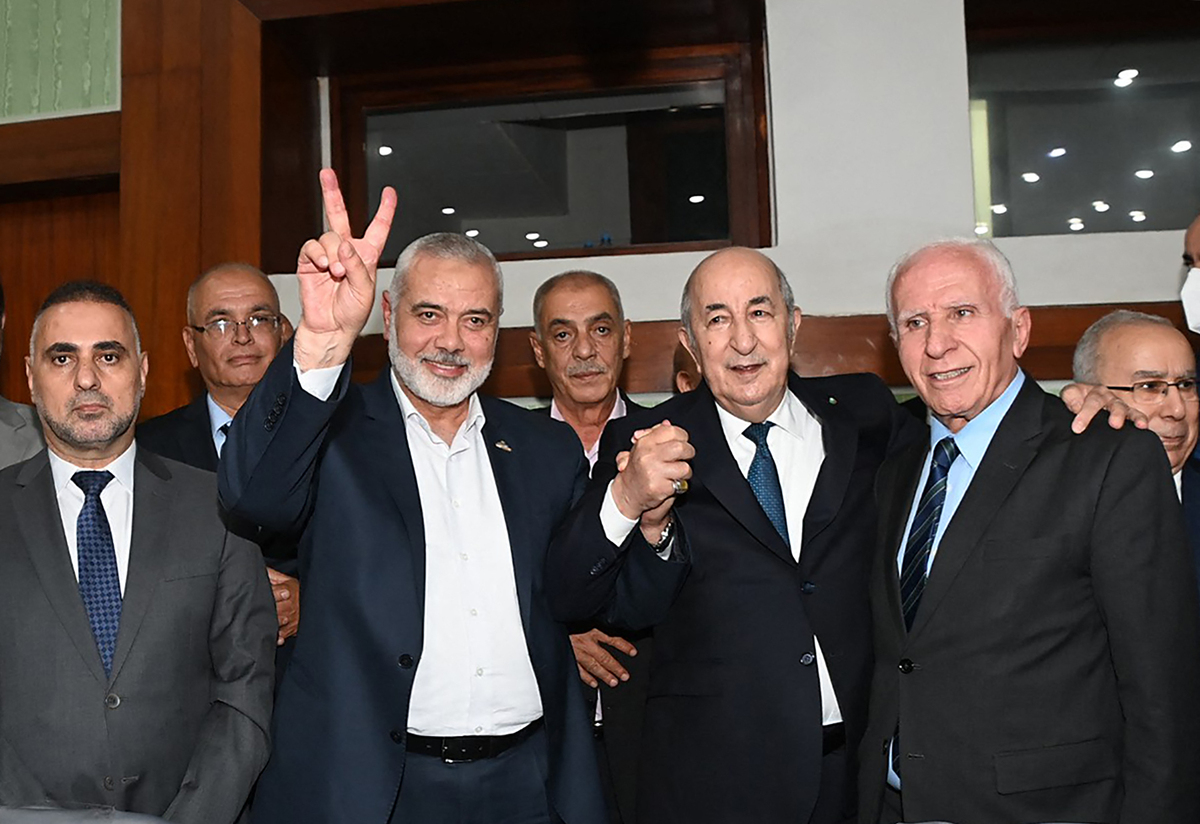 A handout picture provided by the Algerian Presidency's official Facebook Page on October 12, 2022 posing for a picture with the leader of the Palestinian Hamas movement Ismail Haniyeh and Fatah member Azzam al-Ahmad (R) during the inter-Palestinian reconciliation meeting in the capital Algiers. === RESTRICTED TO EDITORIAL USE - MANDATORY CREDIT "AFP PHOTO / HO / ALGERIAN PRESIDENCY FACEBOOK PAGE " - NO MARKETING NO ADVERTISING CAMPAIGNS - DISTRIBUTED AS A SERVICE TO CLIENTS === (Photo by ALGERIAN PRESIDENCY'S FACEBOOK PAGE / AFP) / === RESTRICTED TO EDITORIAL USE - MANDATORY CREDIT "AFP PHOTO / HO / ALGERIAN PRESIDENCY FACEBOOK PAGE " - NO MARKETING NO ADVERTISING CAMPAIGNS - DISTRIBUTED AS A SERVICE TO CLIENTS ===