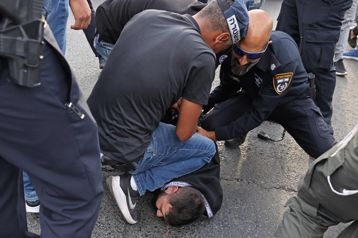 Israeli security forces detain a Palestinian during a protest condemning the death of veteran Al-Jazeera journalist Shireen Abu Akleh, who was shot dead while covering an Israeli army raid in Jenin, in the Palestinian neighbourhood of Beit Hanina in Israeli-annexed east Jerusalem on May 11, 2022. (Photo by AHMAD GHARABLI / AFP)