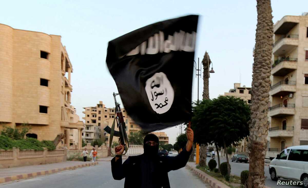 A member loyal to the Islamic State in Iraq and the Levant (ISIL) waves an ISIL flag in Raqqa June 29, 2014. The offshoot of al Qaeda which has captured swathes of territory in Iraq and Syria has declared itself an Islamic "Caliphate" and called on factions worldwide to pledge their allegiance, a statement posted on jihadist websites said on Sunday. The group, previously known as the Islamic State in Iraq and the Levant (ISIL), also known as ISIS, has renamed itself "Islamic State" and proclaimed its leader Abu Bakr al-Baghadi as "Caliph" - the head of the state, the statement said. REUTERS/Stringer (SYRIA - Tags: POLITICS CIVIL UNREST TPX IMAGES OF THE DAY) FOR BEST QUALITY IMAGE ALSO SEE: GF2EAAO0VU501