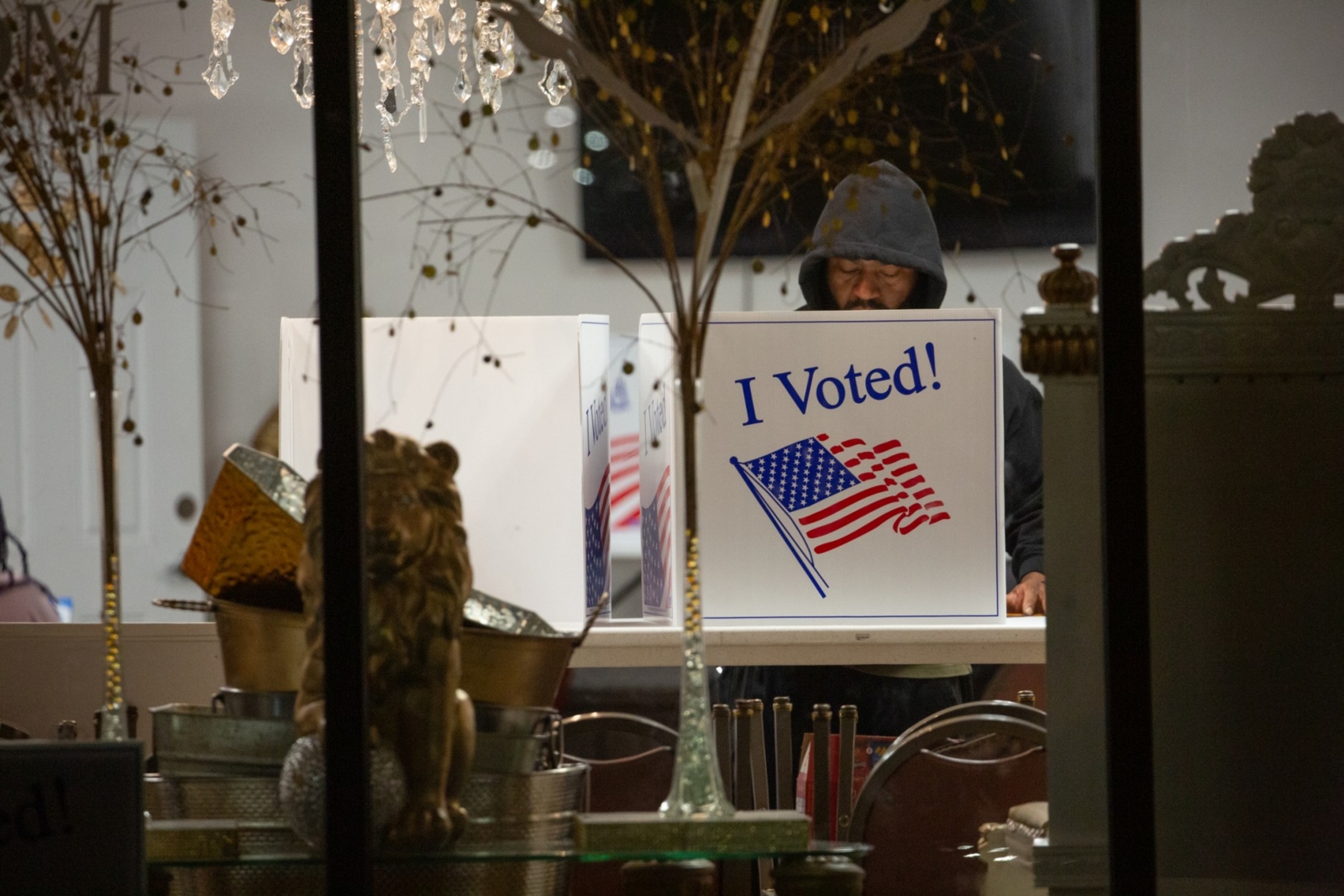 A voter casts his ballot inside a polling place at Elevationz, an event space and resale shop, before polls close for the evening, during the US midterm elections, in Pittsburgh, Pennsylvania, on November 8, 2022. (Photo by Rebecca DROKE / AFP)