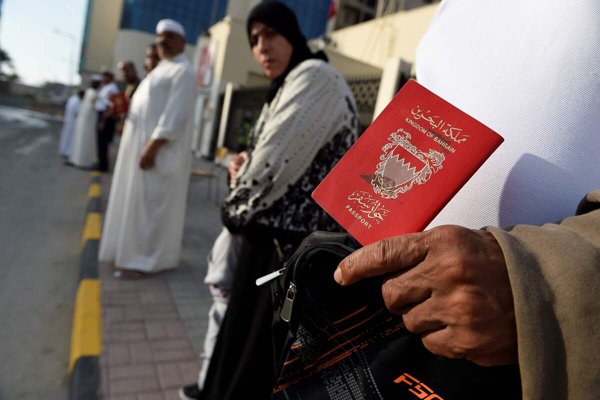 (FILES) In this file photo taken on December 1, 2018, Bahraini voters queue in front of the 1st District polling center in Muharraq island north of the capital. Bahrainis head to the polls on November 12, 2022, but despite a record number of people vying for seats, a ban on opposition candidates means it will bring no meaningful change, rights groups said. (Photo by AFP)