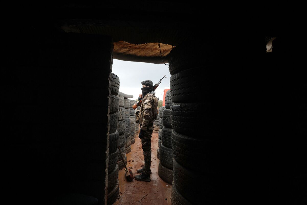 Turkey-backed Syrian fighters man positions on the outskirts of the town of Kuljibrin, in the country's northern Aleppo governorate, facing positions of the Kurdish-controlled area of Tal Rifaat, on November 25, 2022. Since November 20, Turkey has carried out air strikes against the semi-autonomous Kurdish zones in north and northeastern Syria, and across the border in Iraq. Those raids, which started in Kobane, have killed 58 Kurdish fighters and Syrian soldiers as well as a Kurdish journalist, the Syrian Observatory for Human Rights said. Ankara has threatened a ground offensive and made clear that Kobane, also known as Ayn al-Arab, would be a primary objective. (Photo by Bakr ALKASEM / AFP)