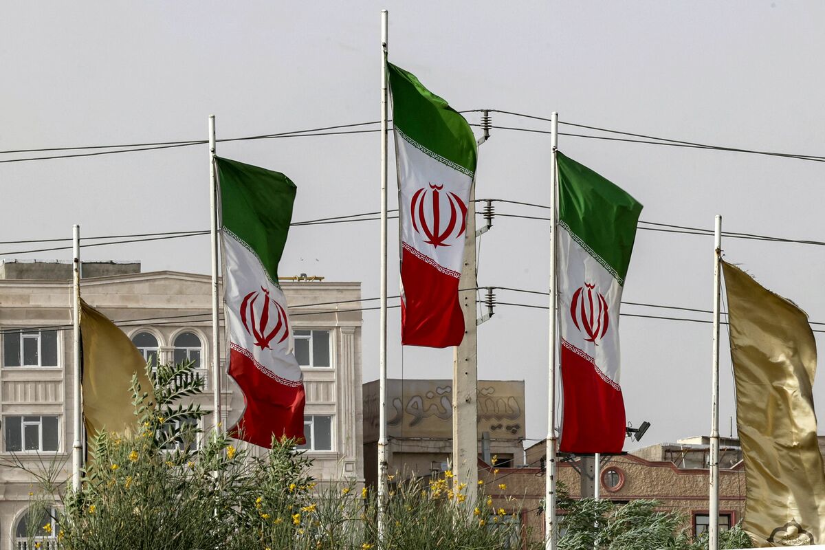 The flags of Iran flutter during a sandstorm in the south of the capital Tehran on July 4, 2022. (Photo by ATTA KENARE / AFP)