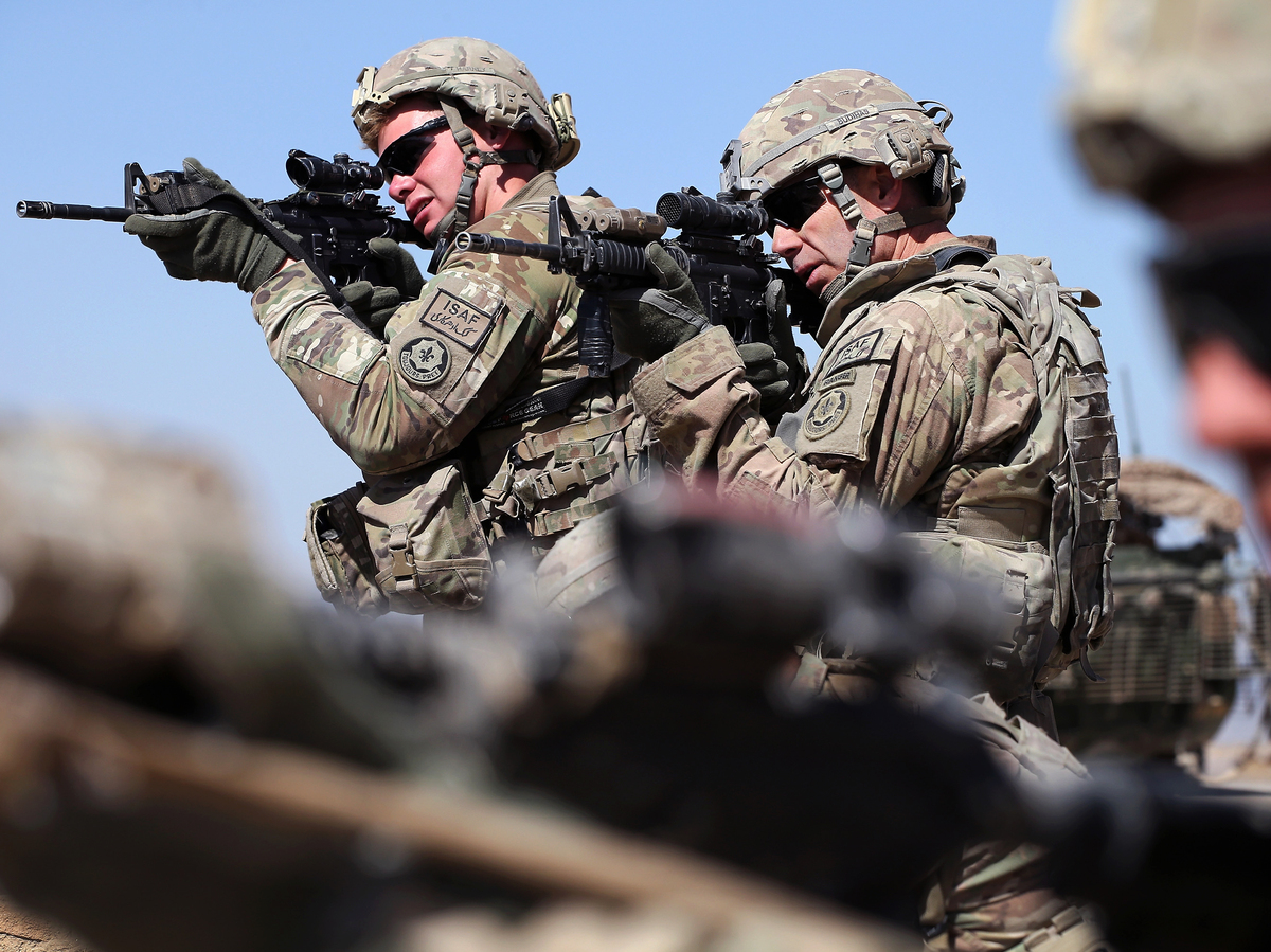 U.S. soldiers look for enemy movement during a joint patrol with soldiers from the Afghan National Army on March 1, near Kandahar, Afghanistan.