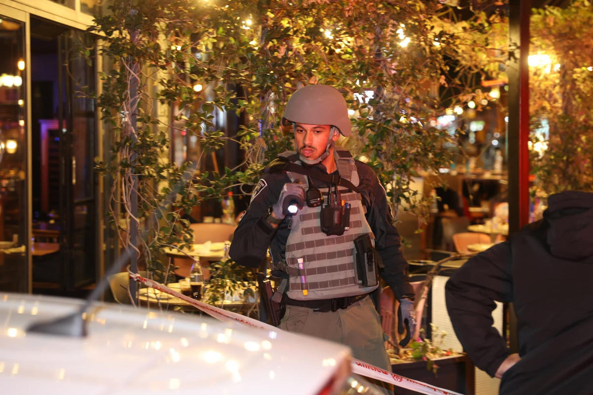 (230309) -- TEL AVIV, March 9, 2023 (Xinhua) -- A policeman works at the scene of a shooting attack on Dizengoff street in Tel Aviv, Israel, on March 9, 2023. A gun-wielding Palestinian man opened fire on a busy street in the Israeli city of Tel Aviv on Thursday night, injuring three individuals in what was described by Israeli officials as a "terror attack." Tel Aviv district police chief Amichai Eshed told reporters at the scene that the gunman opened fire at passersby before fleeing the scene, but was soon chased and killed by a policeman and policewoman. (JINI via Xinhua)