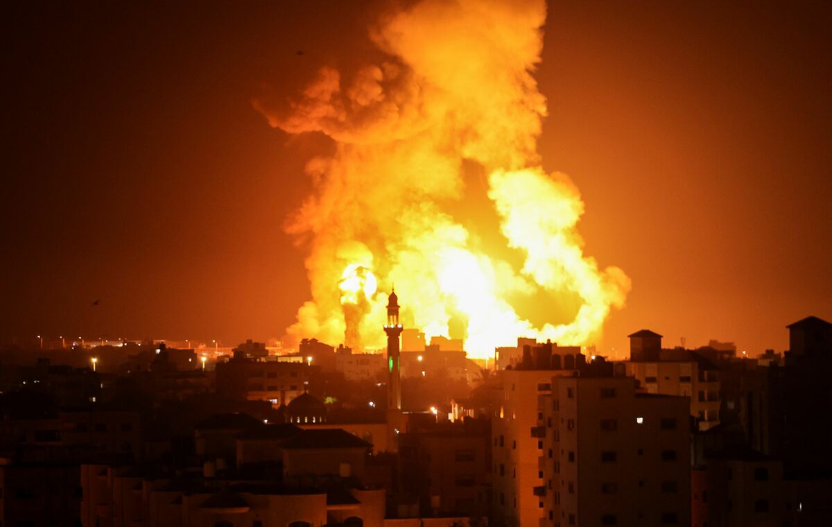 Fires are seen following an Israeli airstrike in Gaza city on July 16, 2022. (Photo by Mahmud HAMS / AFP)