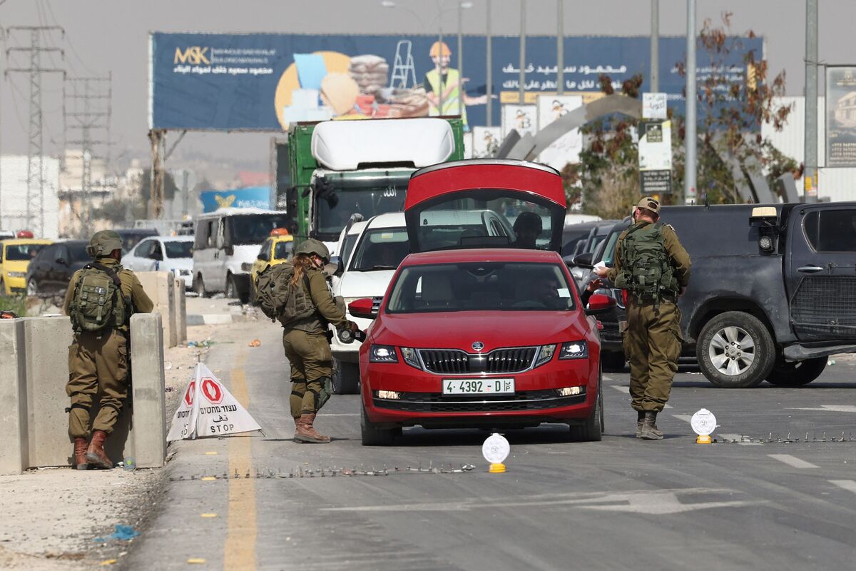 Israeli soldiers search a car at a checkpoint at the entrance of Jericho city in the occupied West Bank, on February 28, 2023. Palestinians in the occupied West Bank on February 27 counted the cost of deadly violence and arson by Israeli settlers targeting a town where two Israeli brothers were killed, in a surge of violence which continued later in the day when gunfire killed an Israeli-American man near Jericho, an attack the army blamed on suspected Palestinian attackers. (Photo by AHMAD GHARABLI / AFP)