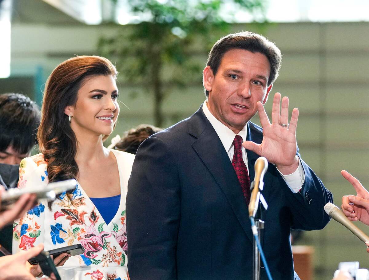 Florida Governor Ron DeSantis (R) waves to journalists as his wife Casey (L) looks one after meeting Japanese Prime Minister Fumio Kishida at the latter's official residence in Tokyo on April 24, 2023. (Photo by Kimimasa MAYAMA / POOL / AFP)