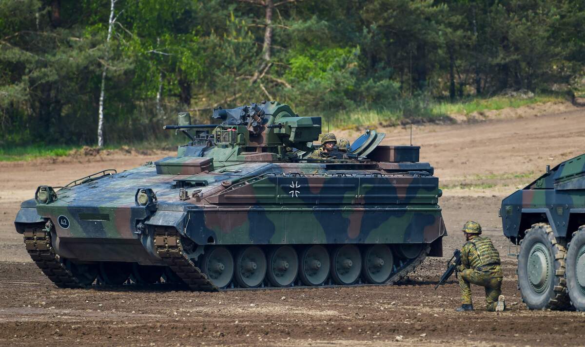 (FILES) This file photo taken on May 20, 2019 shows a Marder battle tank of the German armed forces Bundeswehr driving during an informative educational practice of the "Very High Readiness Joint Task Force (VJTF)", which is part of a NATO tank unit, at the military training area in Munster, northern Germany. Berlin and Washington are coordinating a "qualitative new step" in their weapon deliveries to Ukraine, German government sources told AFP on January 5, 2023, with calls growing for Germany to up its contribution. Germany will follow the US in providing a Patriot missile defence system to Ukraine, and also will deliver Marder tanks. (Photo by PATRIK STOLLARZ / AFP)