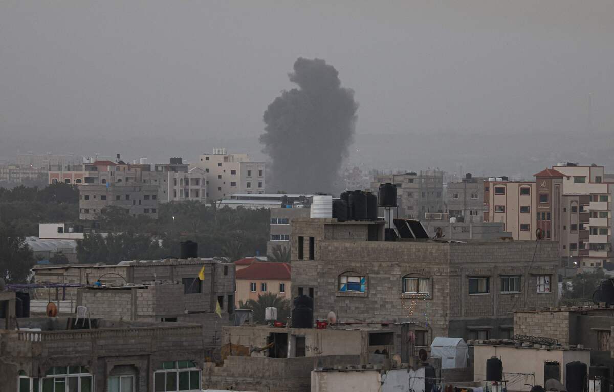 Smoke rises above buildings in Gaza City as Israel launched air strikes on the Palestinian enclave early on April 5, 2023. After the announcement of the clashes at Al-Aqsa early on April 5, several rockets were fired from the northern Gaza Strip towards Israeli territory, according to AFP journalists and witnesses. The Israeli army said five rockets fired from the Gaza Strip were intercepted by the aerial defence system around Sderot in southern Israel, and that four others had fallen in uninhabited areas. Israeli fighter jets later struck two Hamas weapons manufacturing sites in the central Gaza Strip "in response" to the rocket fire, the army said. (Photo by MAHMUD HAMS / AFP)