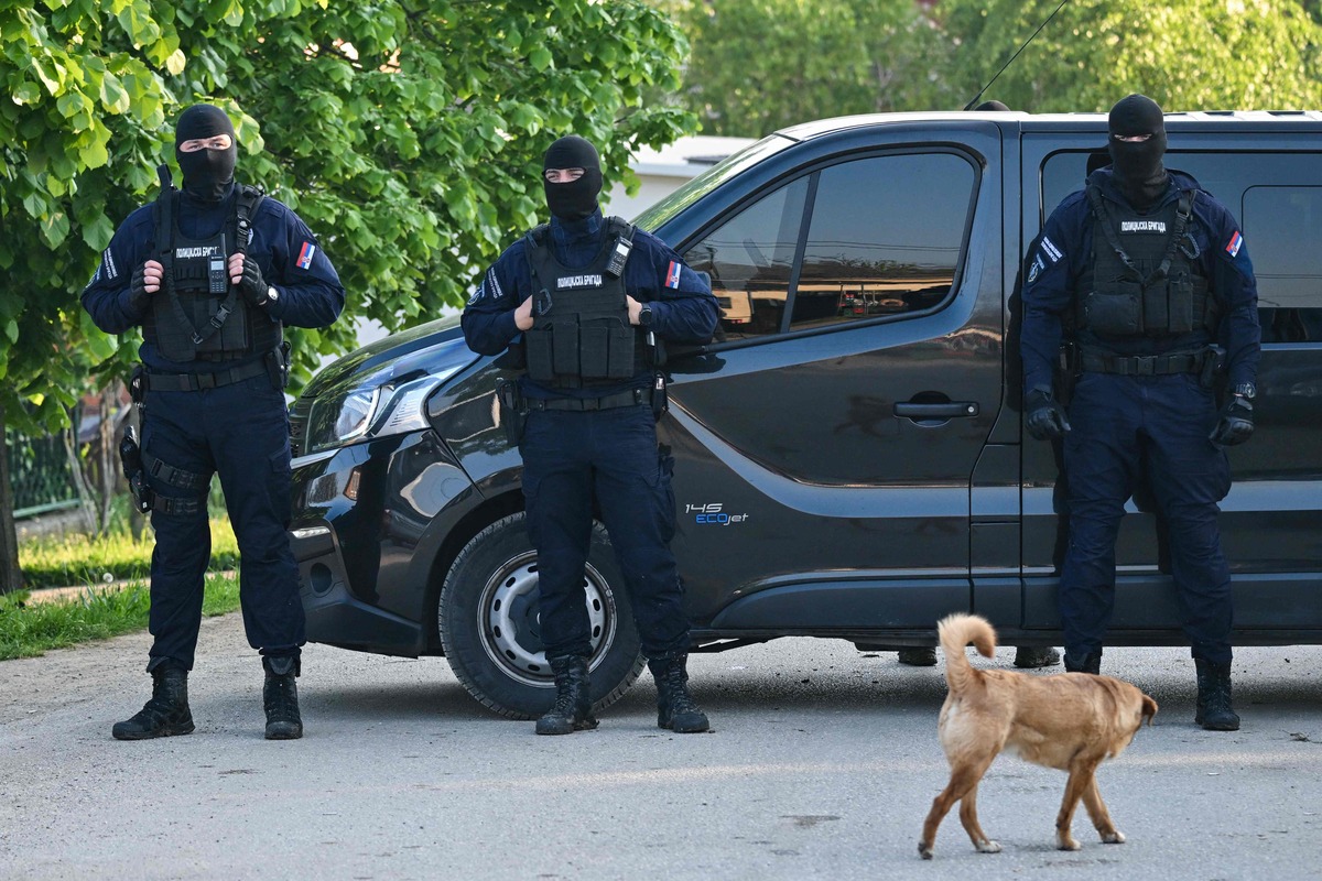 Masked policemen secure an area in the village of Dubona near the town of Mladenovac, about 60 kilometres (37 miles) south of Serbia's capital Belgrade, on May 05, 2023, in the aftermath of a drive-by shooting. A manhunt was ongoing in Serbia early May 5 as police combed the woods near the capital Belgrade, after state media reported a gunman killed at least eight people and injured 13, in the second mass shooting in the Balkan nation this week. (Photo by ANDREJ ISAKOVIC / AFP)