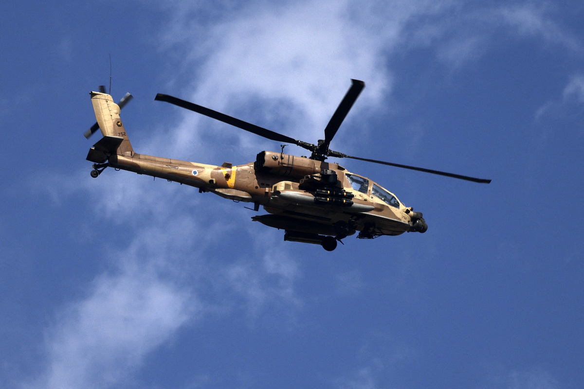 An Israeli helicopter flies during a raid in Jenin in the occupied West Bank on June 19, 2023. Israeli forces in the occupied West Bank killed three Palestinians, in a raid that saw seven Israeli security personnel wounded and rare helicopter fire as the army said it pursued "wanted suspects". (Photo by Jaafar ASHTIYEH / AFP)