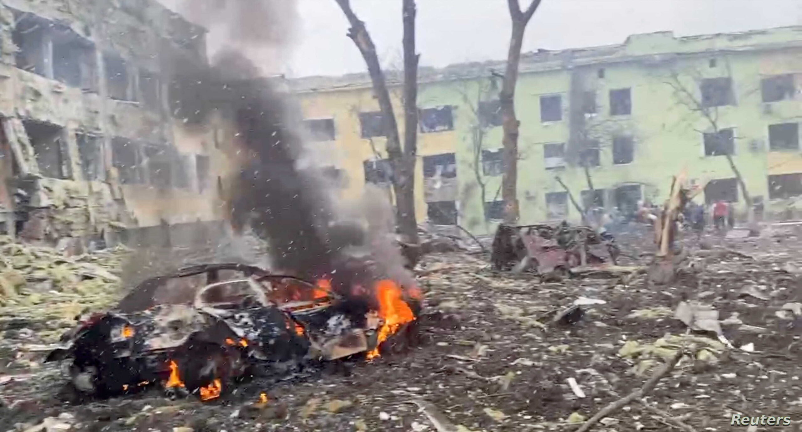 A car burns after the destruction of Mariupol children's hospital as Russia's invasion of Ukraine continues, in Mariupol, Ukraine, March 9, 2022 in this still image from a handout video obtained by Reuters. Ukraine Military/Handout via REUTERS THIS IMAGE HAS BEEN SUPPLIED BY A THIRD PARTY.