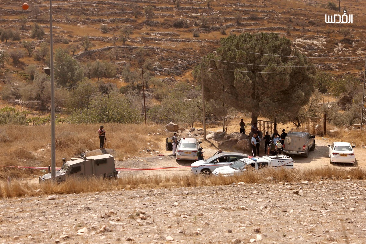 Members of Israeli security forces and emergency services stand on the site of a reported attack in southern Hebron in the occupied West Bank, on August 21, 2023. An Israeli woman was shot dead and another man wounded in a suspected shooting attack when they were driving near Hebron on August 21, medics and the army said. (Photo by HAZEM BADER / AFP)