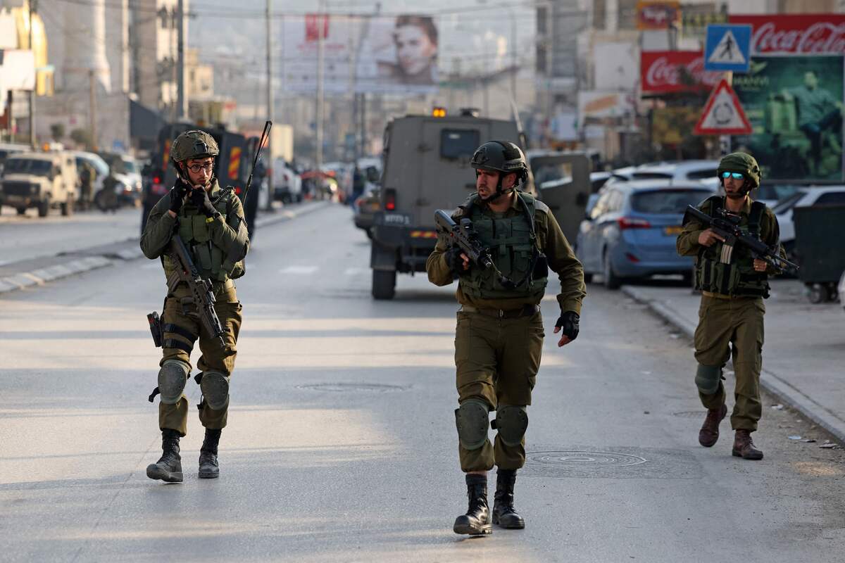 Security forces deploy in the occupied West Bank town of Huwara on February 26, 2023 following the death of two Israelis in a shooting attack. A joint statement from Prime Minister Benjamin Netanyahu and his national security minister, Itamar Ben-Gvir, confirmed "two Israeli civilians were killed in a Palestinian terror attack" after the incident in the northern West Bank. (Photo by AHMAD GHARABLI / AFP)