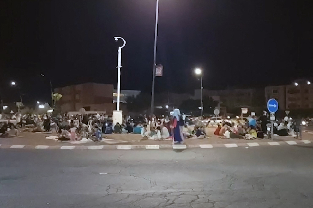 This frame grab from video footage taken by AFPTV shows people out in the open in Marrakesh September 9, 2023, following a 6.8 magnitude earthquake that struck Morocco. Nearly 300 people have died after a powerful earthquake rattled Morocco Friday night, according to a preliminary government count, as terrified residents of Marrakesh reported "unbearable" screams followed the 6.8-magnitude tremor. (Photo by Faisal Baddour / AFPTV / AFP)