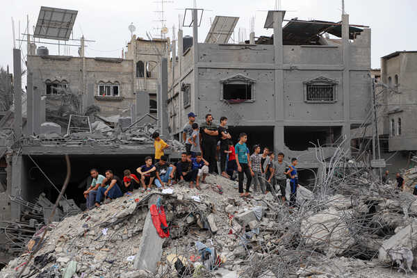 (231027) -- GAZA, Oct. 27, 2023 (Xinhua) -- People are seen among the rubble of buildings destroyed in Israeli airstrikes in the southern Gaza Strip city of Khan Younis, on Oct. 27, 2023. The death toll of Palestinians from Israeli military strikes on the Gaza Strip has risen to 7,326, the Hamas-run Health Ministry said on Friday. Israel has launched massive airstrikes and ground operations against Gaza in retaliation for a surprise attack by Gaza-ruling Hamas militants on Israeli military targets and towns on Oct. 7, which has killed at least 1,400 people in Israel. (Photo by Rizek Abdeljawad/Xinhua)