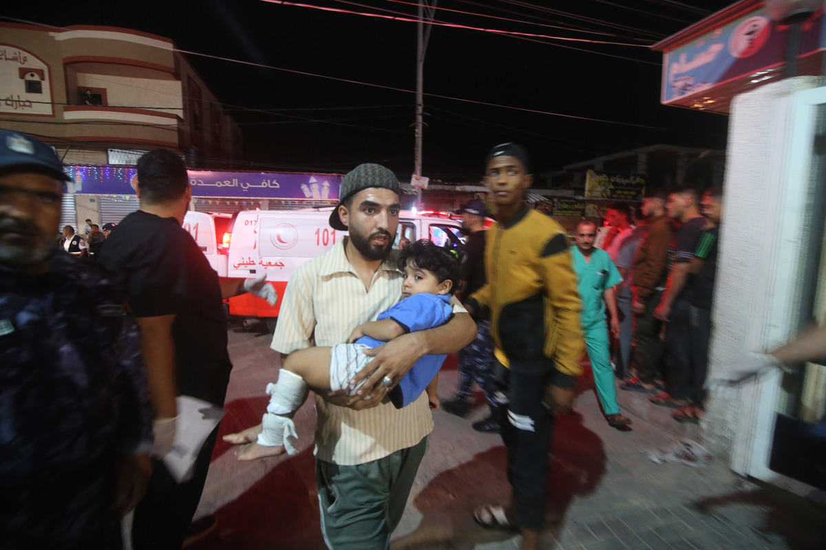 (231009) -- GAZA, Oct. 9, 2023 (Xinhua) -- An injured child is carried into a hospital after wounded in an Israeli airstrike in the southern Gaza Strip city of Rafah, Oct. 8, 2023. Israel's cabinet declared a "state of war" on Sunday after a massive surprise attack launched by Hamas has so far killed at least 700 in Israel while retaliatory Israeli airstrikes killed at least 413 in Gaza. (Photo by Khaled Omar/Xinhua)