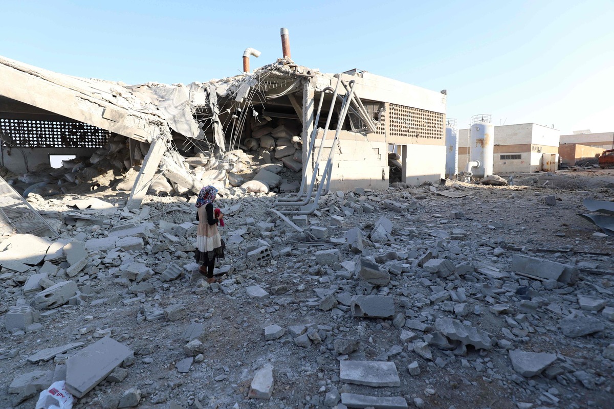 TOPSHOT - A girl stands amidst debris after at least two civilians were killed when Russian air strikes hit an abandoned water pumping station in Syria's rebel-held northwest, on August 23, 2023. (Photo by Abdulaziz KETAZ / AFP)