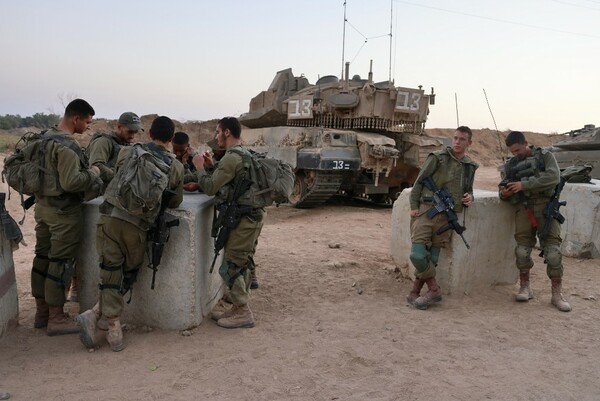 Israeli soldiers stand on alert in an army post near the Israeli Gaza border south of the Israeli city of Sderot on August 24, 2021. (Photo by Menahem KAHANA / AFP)