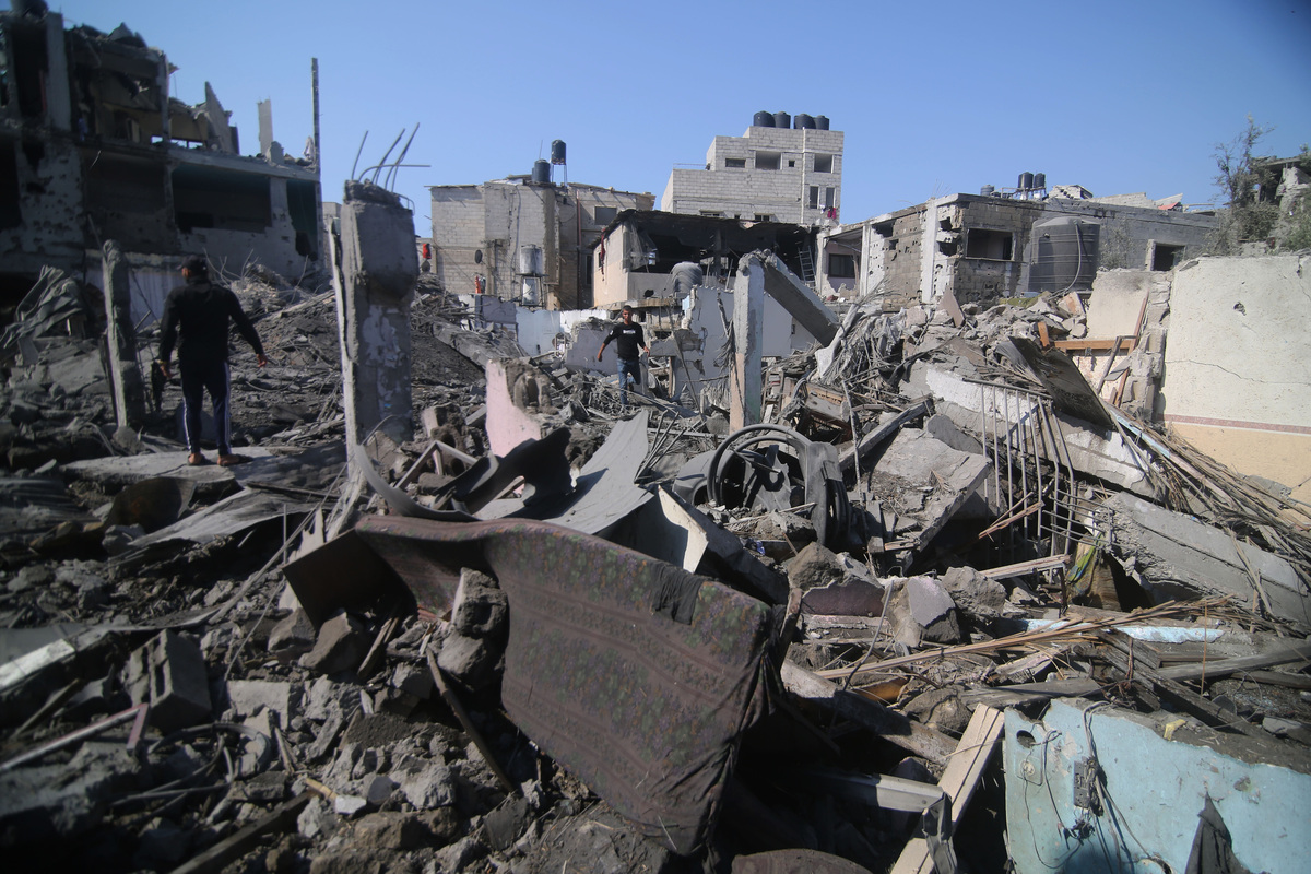 (231011) -- GAZA, Oct. 11, 2023 (Xinhua) -- People inspect buildings destroyed in Israeli airstrikes in the southern Gaza Strip city of Rafah, on Oct. 11, 2023. The Palestinian Islamic Resistance Movement (Hamas) on Saturday launched a surprise attack on Israeli towns adjacent to the Gaza Strip, prompting Israel to launch retaliatory strikes on Gaza. As of Wednesday, more than 2,000 people have been killed and thousands more injured on both sides. (Photo by Khaled Omar/Xinhua)