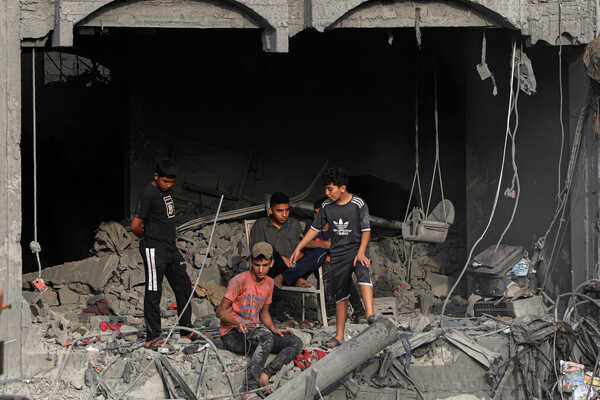 (231025) -- GAZA, Oct. 25, 2023 (Xinhua) -- Palestinian boys are seen in a damaged building after Israeli airstrikes in the Southern Gaza Strip city of Khan Younis, Oct. 25, 2023. The death toll of Palestinians from Israeli airstrikes on the Gaza Strip has risen to 6,546, the Hamas-run Health Ministry said on Wednesday. (Photo by Rizek Abdeljawad/Xinhua)