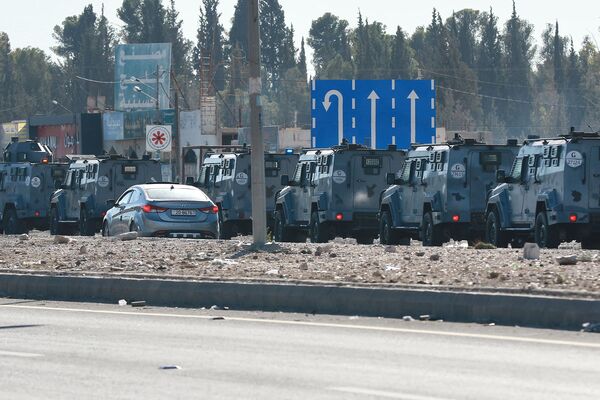 Jordanian security forces deploy their armoured vehicles in the southern city of Maan, some 220 kms south of the capital Amman, on December 16, 2022 hours after a senior police officer was shot dead in riots during a strike against rising fuel prices in the area. Gunfire killed a senior Jordanian officer and wounded two other policemen last night in the country's south, where protesters have taken to the streets for days against high fuel prices, according to the Jordanian authorities. (Photo by Khalil MAZRAAWI / AFP)