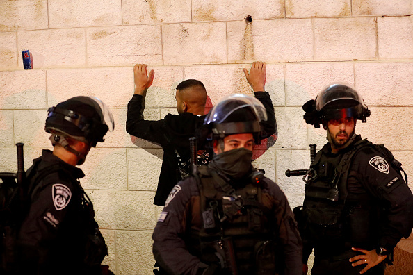 Israeli security forces detain a man as they clash with Palestinians following the funeral of Walid al-Sharif, 23, who died of wounds suffered last month during clashes with Israeli police at Jerusalem's flashpoint al-Aqsa mosque compound, on May 16, 2022 outside the Old City of Jerusalem. - Sharif, 23, was taken to Hadassah Ein Kerem hospital with a "head injury" on April 22 and he was "pronounced dead this morning", the hospital said in a statement. (Photo by Ahmad GHARABLI / AFP) (Photo by AHMAD GHARABLI/AFP via Getty Images)