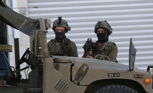 (230312) -- NABLUS, March 12, 2023 (Xinhua) -- Israeli soldiers are seen near the scene where three Palestinians were killed, near the West Bank city of Nablus, March 12, 2023. Three Palestinians were killed on Sunday in the exchange of fire with Israeli soldiers near the northern West Bank city of Nablus, Palestinian medics and Israeli sources said. (Photo by Nidal Eshtayeh/Xinhua)