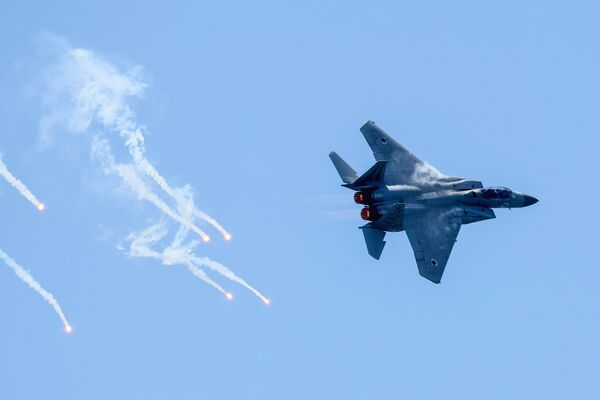 Israeli Air Force pilots fly an F-15D Eagle fighter jet during a rehearsal for the upcoming Independence Day air show in Tel Aviv on April 24, 2023. (Photo by Jack GUEZ / AFP)