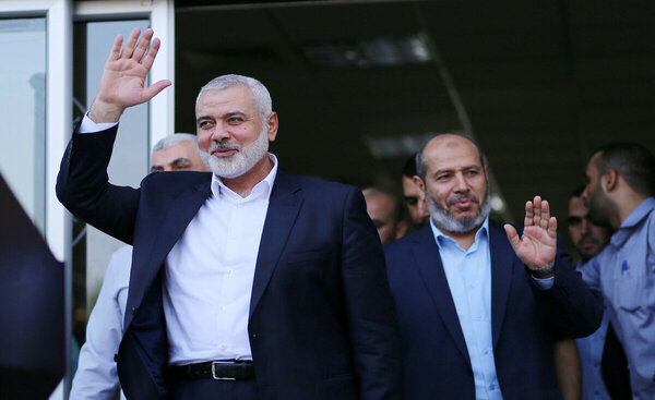 Hamas Chief Ismail Haniyeh waves to journalists upon his arrival on the Palestinian side of the Rafah border crossing, in the southern Gaza Strip on September 19, 2017. Haniyeh said on Tuesday evening that his movement is ready to receive the Palestinian Unity Government in Gaza during a press conference held immediately after returning to the Gaza Strip from Cairo, he said: To show Hamas seriousness to bring about reconciliation, we invite the unity government to come and assume its duties in Gaza unimpeded.. Photo by Yasser Qudih