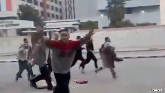 A person gestures as individuals, reportedly freed prisoners, run in the streets of Damascus, Syria, December 8, 2024, in this picture obtained from social media video. Nedal Al-Amari/via REUTERS THIS IMAGE HAS BEEN SUPPLIED BY A THIRD PARTY. MANDATORY CREDIT. NO RESALES. NO ARCHIVES.