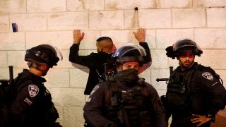 Israeli security forces detain a man as they clash with Palestinians following the funeral of Walid al-Sharif, 23, who died of wounds suffered last month during clashes with Israeli police at Jerusalem's flashpoint al-Aqsa mosque compound, on May 16, 2022 outside the Old City of Jerusalem. - Sharif, 23, was taken to Hadassah Ein Kerem hospital with a "head injury" on April 22 and he was "pronounced dead this morning", the hospital said in a statement. (Photo by Ahmad GHARABLI / AFP) (Photo by AHMAD GHARABLI/AFP via Getty Images)